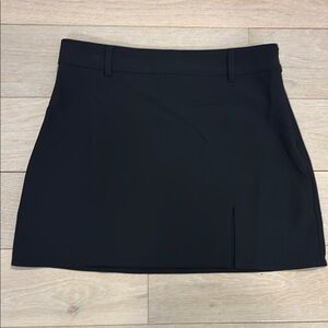 Forever 21 black mini skirt with front side slit. Side zip. Size M.